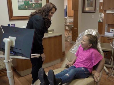 young girl smiling in the dental chair during her appointment at Family Dental Center in Nampa, ID